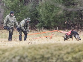 Sûreté du Québec officers investigate the scene of the double homicide in a field in Vaudreuil-Dorion on Dec. 2, 2016.