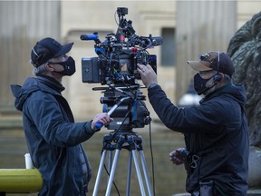 Two cameramen checking equipment during filming of The Batman movie outside St. George's Hall on October 14, 2020 in Liverpool, England. Filming began in January 2020 but was put on hold due to the Coronavirus pandemic.