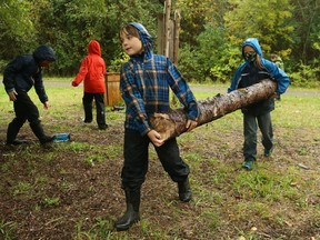 Teddy (L) and Brennan (R), grade 4 students at Rivière Rideau school in Kemptville, help build an outdoor structure during forest school period, October 07, 2020.