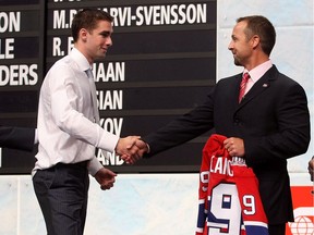 Canadiens assistant GM Trevor Timmins shakes hands with Louis Leblanc after selecting him in the first round (18th overall) of the 2009 NHL Draft at the Bell Centre in Montreal.