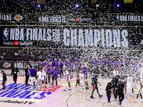 The Lakers celebrate with the trophy after winning the NBA championship over the Heat in Game 6 of the 2020 NBA Finals at AdventHealth Arena at the ESPN Wide World Of Sports Complex in Lake Buena Vista, Fla., on Oct. 11, 2020.