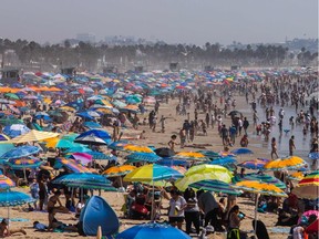 People gather on the beach on the second day of the Labour Day weekend amid a heatwave in Santa Monica, Calif., on Sept. 6, 2020.