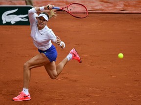 Canada's Eugenie Bouchard returns the ball to Poland's Iga Swiatek during their women's singles third round tennis match on Day 6 of The Roland Garros 2020 French Open tennis tournament in Paris on October 2, 2020.
