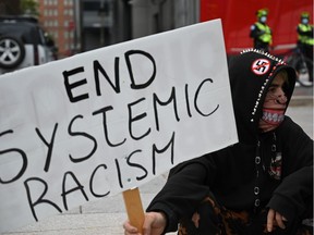 Protesters gather during a demonstration in central Montreal on October 3, 2020, to demand action for the death of Joyce Echaquan, an indigenous woman subjected to live-streamed racist slurs by hospital staff before her death.