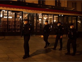 Police officers patrol, on October 17, 2020 in Paris, at the start of a curfew implemented to fight the spread of the Covid-19 pandemic caused by the novel coronavirus.