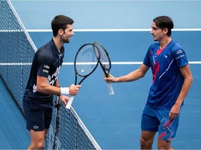 Italy's Lorenzo Sonego, right, is congratulated by Serbia's Novak Djokovic after the quarter-final match at the ATP tennis tournament in Vienna, Austria, on Friday, Oct. 30, 2020.