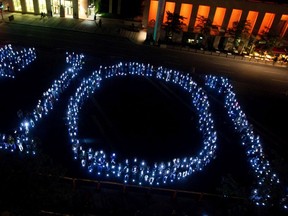 400 people hold candles that form the shape of 101, in reference to Bill 101, as they protest the use of the English language in the city of Montreal on Wednesday, September 18, 2013.