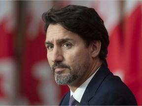 Prime Minister Justin Trudeau looks around the room during a news conference Friday October 23, 2020 in Ottawa. Trudeau was not as optimistic as U.S. President Donald Trump about the possibility of vaccines being distributed before the end of the year.