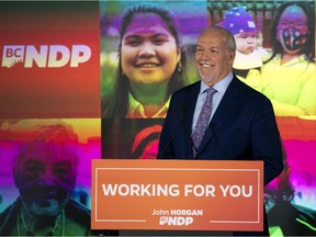 NDP Leader John Horgan celebrates his election win in the British Columbia provincial election in downtown Vancouver, B.C., Saturday, Oct. 24, 2020.