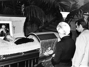 Quebec Premier Robert Bourassa and his wife, Andrée Simard, kneel before the casket of Pierre Laporte on Oct. 20, 1970 at the Montreal courthouse.