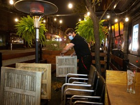 An employee dismantles the terrasse at closing time on Sept. 30 in Montreal. "We are, as the pre-eminent social psychologist Elliot Aronson puts it, social animals," Elliott S. Lee writes.