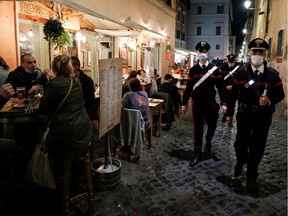 Carabinieri officers patrol the streets in Trastevere before a curfew imposed by the region of Lazio from midnight to 5 a.m to curb the coronavirus disease (COVID-19) infections in Rome, Italy, October 23, 2020. REUTERS/Guglielmo Mangiapane