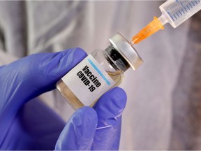 A small bottle labeled with a "Vaccine COVID-19" sticker and a medical syringe in this illustration taken April 10, 2020.