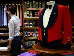 Head Shirt Cutter Tom Bradbury looks at silk ties displayed for sale in the Dege & Skinner tailors on Savile Row, amid the coronavirus disease (COVID-19) outbreak, in London, Britain October 7, 2020. William Skinner is a fifth-generation tailor and the third to run the Savile Row shop Dege & Skinner. Established in 1865, Dege & Skinner is one of only two family-owned Savile Row firms. Its clients include businessmen, generals and royals including Prince Harry, who chose the brand for his wedding uniform. Business has been "quite challenging," but since reopening in June, the shop has seen "quite a lot" of new customers. "It's been on their bucket list for a long time," Skinner said about some of his new customers, who think: "if I get COVID, then I might never do this, so let's do it now'." "There's a whole raft of attitudes out there ... feedback we've had from some of our clients is 'we've had nothing to spend our money on over the last 3-6 months, so I'm going to buy a new suit'." Nevertheless, orders for the past six months are about one-quarter of what they would normally be. The company usually makes about 500-600 suits a year, starting at £5,500 each. Picture taken October 7, 2020. REUTERS/Hannah McKay