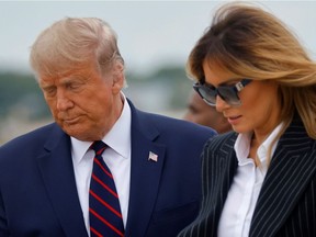 U.S. President Donald Trump walks with first lady Melania Trump at Cleveland Hopkins International Airport in Cleveland, Ohio, U.S., September 29, 2020. Picture taken September 29, 2020. REUTERS/Carlos Barria