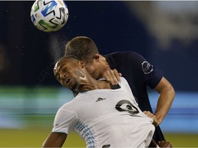 Minnesota United forward Mason Toye, front, heads the ball against Sporting Kansas City defender Matt Besler during the first half in Kansas City on Sept. 13, 2020.