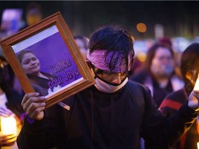 A man attends a vigil on Tuesday, Sept. 29, 2020 in front of the hospital in Joliette where Joyce Echaquan died.