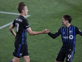 Montreal Impact midfielder Lassi Lappalainen (21) celebrates his goal  with forward Bojan Krkic (9) during the first half against the Chicago Fire at Red Bull Arena in Harrison, N.J., on Saturday, Oct. 3, 2020.