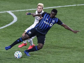 Montreal Impact midfielder Victor Wanyama (2) controls the ball as New England Revolution forward Diego Fagundez (14) defends during the second half at Red Bull Arena Oct. 14, 2020.