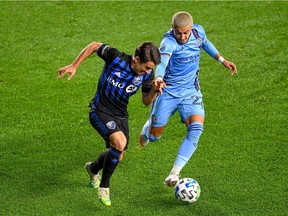 New York City defender Ronald Matarrita (22) and Montreal Impact forward Bojan Krkic (9) battle for the ball during the first half of the match between the New York City and the Montreal Impact at Yankee Stadium on Saturday, Oct. 24, 2020, in New York.