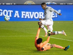 Impact forward Romell Quioto leaps over Philadelphia goalkeeper Andre Blake and fails to score during second half of Impact’s 2-1 loss to the Union at Subaru Park in Chester, Pa.