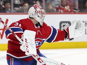 Montreal Canadiens' Carey Price makes a glove save during second period against the Calgary Flames in Montreal on Jan. 13, 2020.