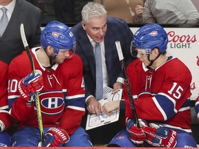Montreal Canadiens assistant coach Dominique Ducharme talks strategy with Joel Armia, left, and Jesperi Kotkaniemi during third period of game against the Florida Panthers in Montreal on Jan. 15, 2019.