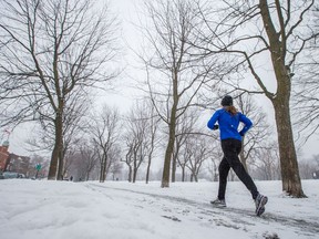 A woman runs in the snow at Jeanne-Mance park on Feb. 24, 2016.