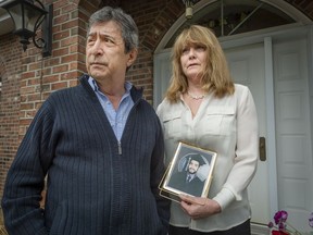 Cesur Celik and his wife, June Tyler, are seen at their home in May 2019. Tyler holds a portrait of her son, Koray Kevin Celik, taken at the University of Southern Maine.