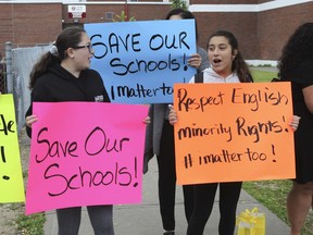 Students, former students, parents and teachers take part in a 'human chain' protest outside of an English elementary school in the St-Léonard area of Montreal, on Thursday, June 20, 2019. Declining enrolment at English schools has led to school closures and the transfer of buildings to the French sector to relieve overcrowding in French schools.