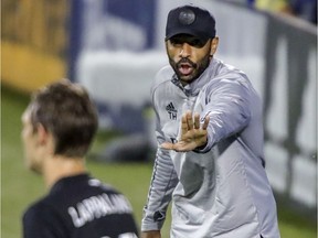 Montreal Impact head coach Thierry Henry gives instructions to midfielder Lassi Lappalainen during MLS game against the Vancouver Whitecaps in Montreal on Aug. 25, 2020.