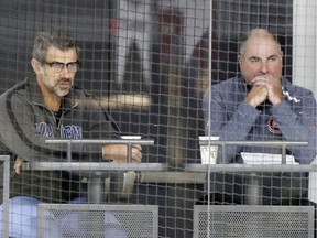Larry Carrière, right, and Canadiens general manager Marc Bergevin watch training camp practice at the Bell Sports Complex in Brossard on Sept. 14, 2018.