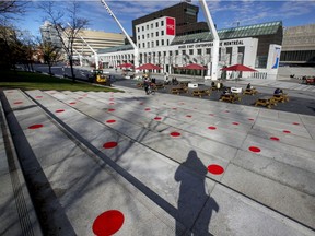 How far is two metres? Red social distancing dots on a terrace at Place de Festivals mark the spot.