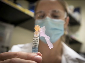 Nurse Jessica Mann Bourgouin prepares to administer a flu shot in October 2020.
