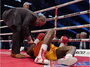 Adonis Stevenson is examined after being knocked out by Oleksandr Gvosdyk during their WBC light heavyweight championship fight at the Videotron Centre on Dec. 1, 2018 in Quebec City.