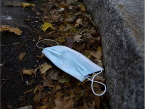 A discarded face mask litters the street.