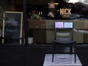 Rob Callard, the owner of the Chez Nick in Westmount, is protesting the Quebec government's red-zone closures by placing an empty chair outside his restaurant.