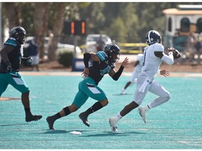 Lachine native and University of Coastal Carolina linebacker Enock Makonzo, centre, pursues Georgia Southern quarterback Shai Werts during game on Oct. 24 in Conway, S.C. Coastal Carolina won 28-14.