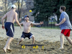 Jérémy Sauvageau, from left, Joël Soucy and Alexandre Marcoux play spikeball on an unseasonably warm day in Montreal on Thursday. Enjoy this warm spell while you can, before the real November shows up, Josh Freed urges readers.