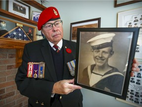 Henry F. Hall holds a photo of his father, Henry Radway Hall, at his home in Hudson. Under normal circumstances, the retired lieutenant-colonel would be at the Alexis Nihon Plaza with fellow veterans handing out poppies this week.