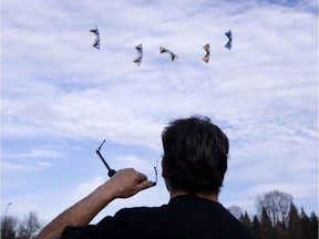 Members of Le Quebec Force, a 10 flyer strong acrobatic kite flying team, practice in Jarry Park on Nov. 9, 2020.