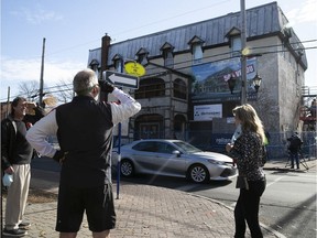 People have a last look at the Pioneer bar in Pointe-Claire Village as workers get ready to start the demolition of the building on Tuesday, Nov. 10, 2020.