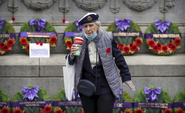 96 year-old veteran Violet Drummond walks past the Cenotaph prior to scaled-down Remembrance Day ceremony in Montreal's Place du Canada in 2020.
