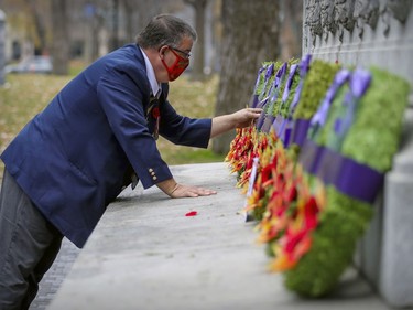 Royal Canadian Legion member Robert Brosseau lays wreaths prior to a scaled-down Remembrance Day ceremony at the Cenotaph in Montreal's Place du Canada in 2020.  Wreaths from various organizations and groups were put in place before the ceremony to limit the number of people in attendance.