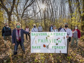 Save the Fairview Forest members gather in the wooded area west of the Fairview Pointe-Claire shopping centre, on Tuesday. Cadillac Fairview wants to develop the woods.