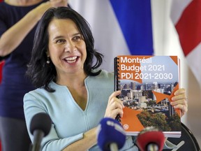 Montreal Mayor Valérie Plante holds up a copy of the city's budget for the coming year at a press conference on Thursday November 12, 2020.