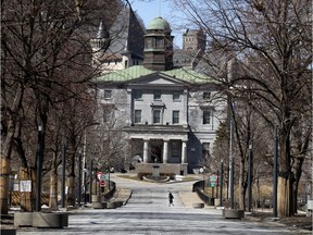 A lone pedestrian cross the McGill University campus as the city looks like a ghost town during the COVID-19 pandemic on March 22, 2020.
