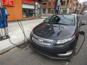 An electric car hooked up to a curbside charging station in Montreal.