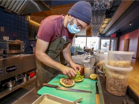 Chef-owner Aaron Langille makes a duck breast ham with fermented cabbage and homemade ketchup on hotteok-inspired bread sandwich at his Le Diplomate restaurant in Mile Ex.