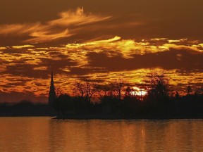The sun sets along Lac St. Louis in Pointe-Claire Village last week.